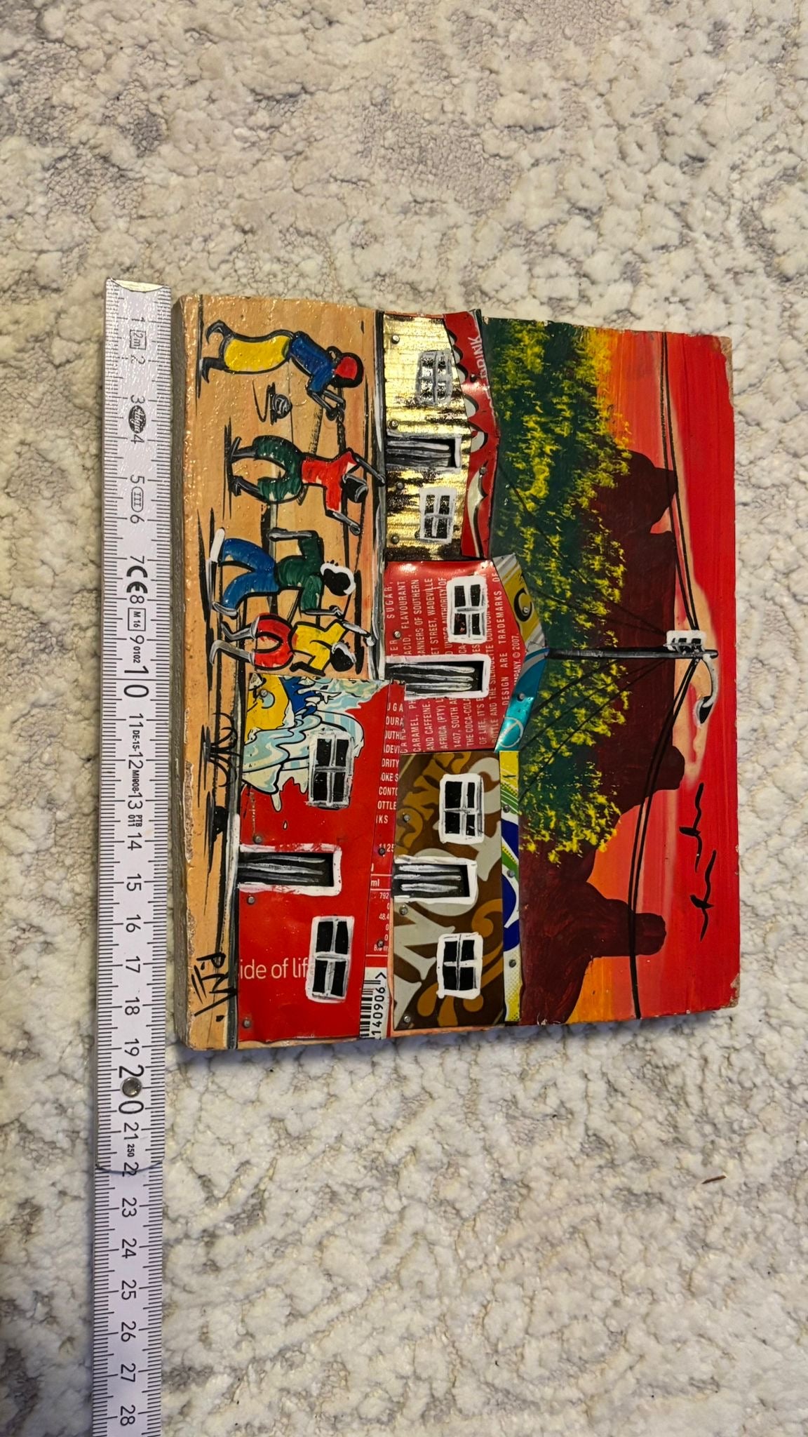 Haitian recycled-tin folk art painting, signed “RAM”, multicolor, 23×18 cm, good